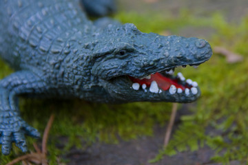 Decorative crocodile in the garden. Rubber statuette of a green crocodile