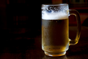 Cold beer on a wooden table in a restaurant