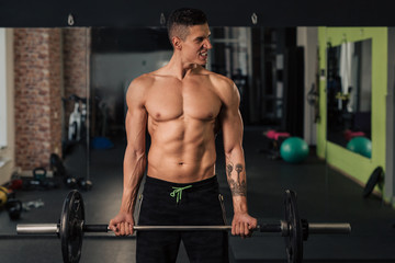 Fototapeta na wymiar Young muscular man in the gym doing exercise