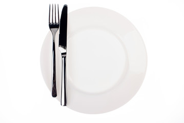 Empty white plate with the knife and fork on white background