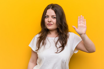 Young curvy plus size woman smiling cheerful showing number five with fingers.