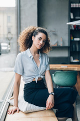 young caucasian woman sitting and looking camera