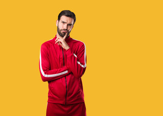 Young fitness man doubting and confused