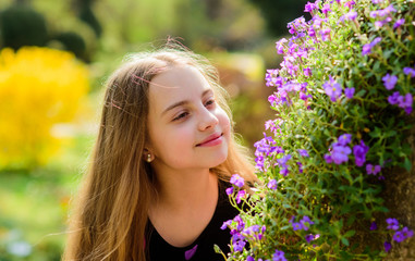 summer nature. Natural beauty. Childhood happiness. little girl smell blooming flowers. Spring holiday. Womens day. happy child with bush bloom. Memorize this moment
