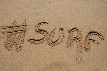 hashtag written by hand in the sand