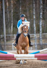 Woman horseback riding and showjumping