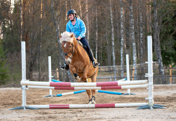 Woman horseback riding and showjumping