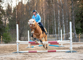 Woman horseback riding and showjumping