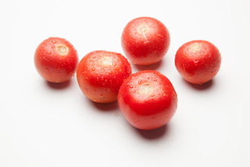 Tomate, rojo, sano con gotas de agua sobre fondo blanco
