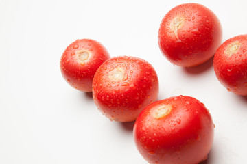 Tomate, rojo, sano con gotas de agua sobre fondo blanco