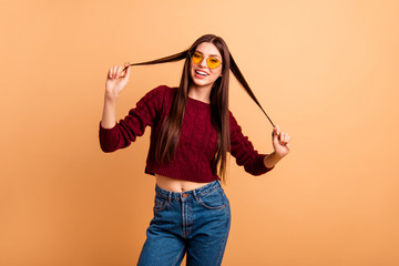 Close up photo beautiful amazing she her lady ideal plump lips sincere self-confident easy-going playing curls wear sun specs casual red burgundy knitted pullover isolated pastel beige background