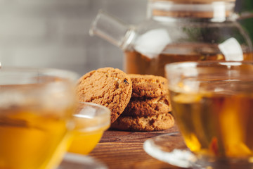 Cup of tea with lemon and honey on wooden background.