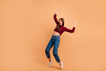 Fototapeta na wymiar Full length side profile body size photo beautiful she her lady ideal appearance look dancing star queen hands arms raised wear casual red burgundy knitted pullover isolated pastel beige background