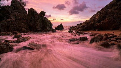 Long exposure image of Dramatic sky seascape with rock in sunset scenery background