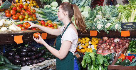 seller woman who is holding tomato