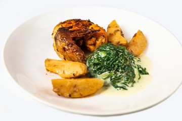 Chicken wing, potato and spinach, isolated on white.