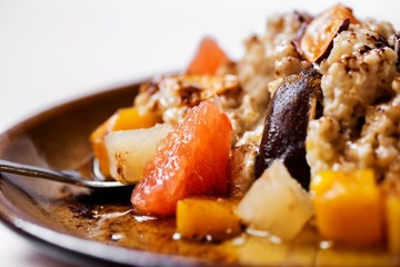 Closeup oatmeal porridge with fruit.