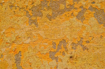 background of yellow-orange wall with cracked paint