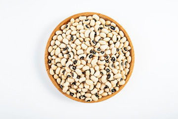 Dried rice bean beans on a saucer on a white background