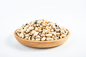 Dried rice bean beans on a saucer on a white background