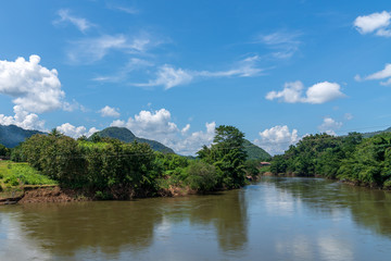 Blue sky high peak mountains fog hills mist scenery river lake dam bay gulf wildlife  National park views Kanchanaburi, Thailand.