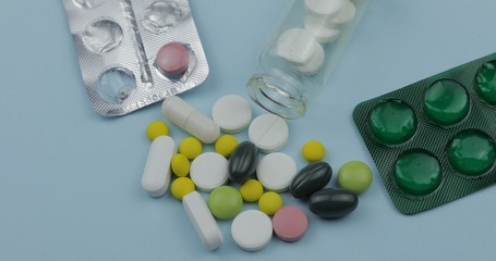 Many pills and drugs. Pills and tablets, blister packs. Blue background