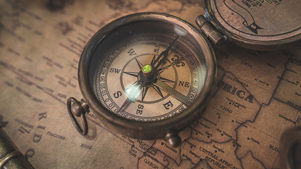 Fototapeta na wymiar Antique Bronze Compass On Old World Map