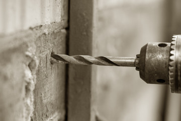 drilling holes in a brick wall close up