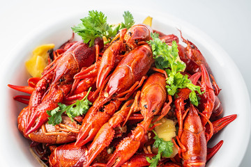 A large bowl of bright red delicious braised crayfish on a white background