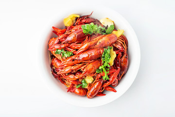 A large bowl of bright red delicious braised crayfish on a white background