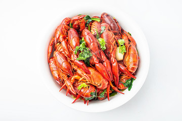 A large bowl of bright red delicious braised crayfish on a white background