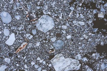 Aierial view from the top down on ice floes floating on the river.
