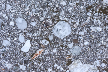 Aierial view from the top down on ice floes floating on the river.