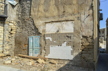 wall of demolished house in old city Baku