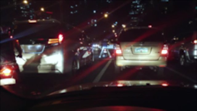 Car stuck in traffic at night while raining in Manila