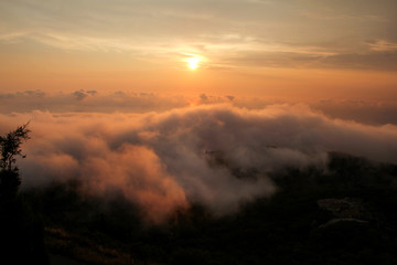 Beautiful structure of clouds on sky, mountain landscape with dense fog at sunset on horizon of beauty natural environment. Panorama of amazing sunrise view show sun rays through clouds over mountain.