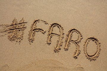 hashtag written by hand in the sand