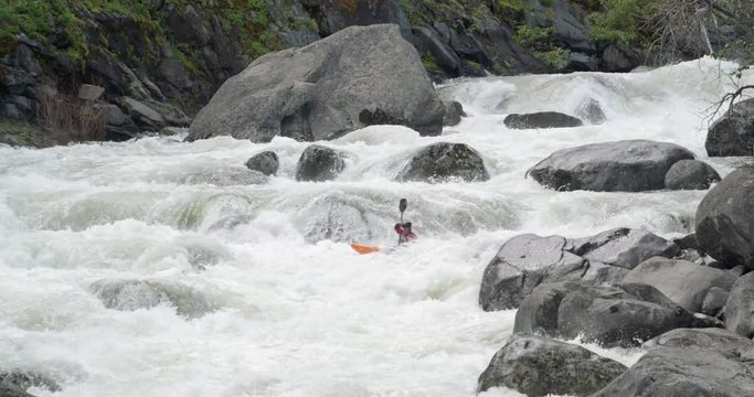 Man Kayaking River Rapids in Massive Rock Boulders by Leavenworth Washington