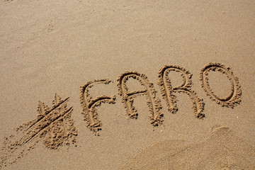 hashtag written by hand in the sand
