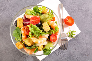 shrimp salad in bowl with tomato and lettuce