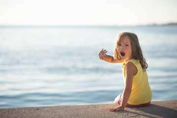 Portrait of amazed girl child at the lakeside
