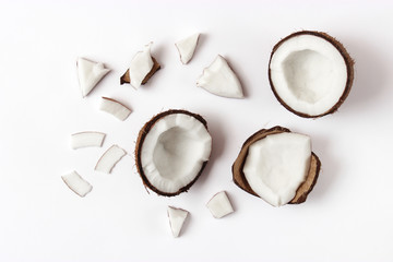 broken coconut on a white background top view.