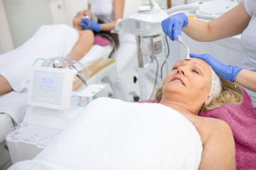 Women enjoying in sap center on facial treatment
