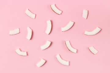 broken coconut on a colored background top view.