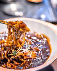 Jajangmyeon, jjajangmyeon, fried sauce noodle, delicious korean traditional noodles cuisine with korea black bean paste sauce, close up, copy space