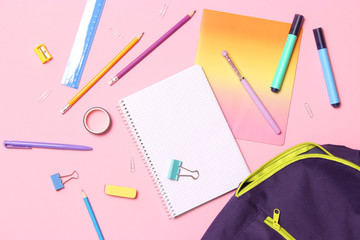 School stationery and school backpack on a colored background top view. concept: back to school