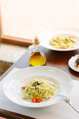 Traditional italian fettuccine pasta with pesto in italian restaurant.