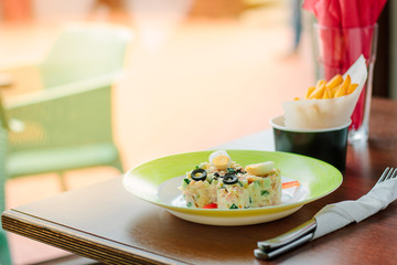 Kid food - potato salad with eggs in a form of butterfly.
