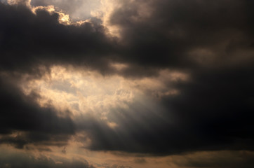 Dramatic dark cloud with sun rays