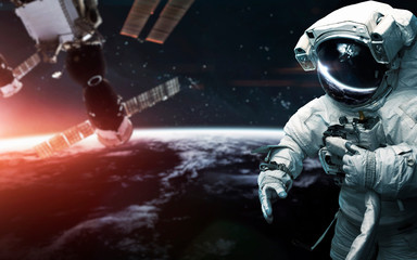 Look on our planet from orbit and astronauts at the spacewalk. Elements of this image furnished by...